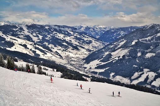 A beautiful shot of people doing ski on the snow in Saalbach-Hinterglemm in Hinterglemm, Austria