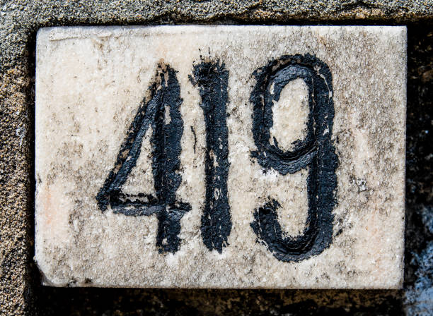 istock Closeup of the number 419 on the rustic white wall 1461590951