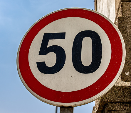 A closeup shot of a circle-shaped sign with the number 50