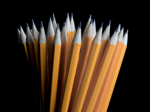 A closeup of pencils on a black background
