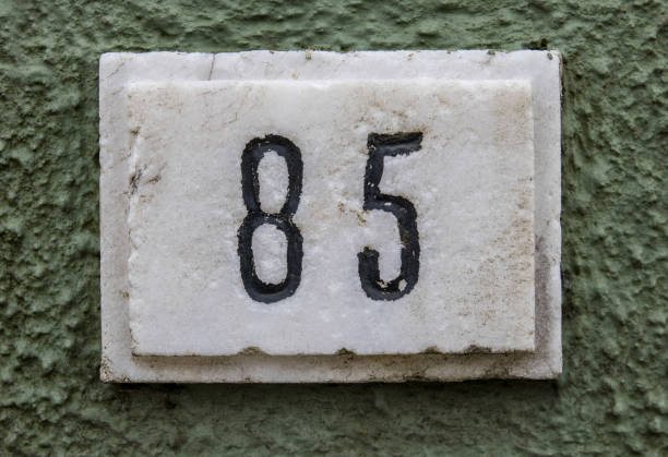 istock Closeup of the number 67 on the rustic white wall 1461590976