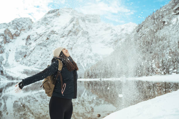 istock Young winter woman playing with snow 1461591100