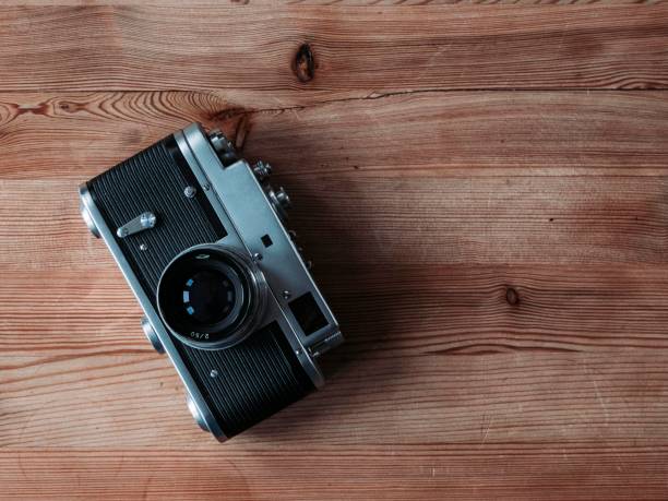 istock Closeup shot of a retro camera on a wooden surface 1461591920