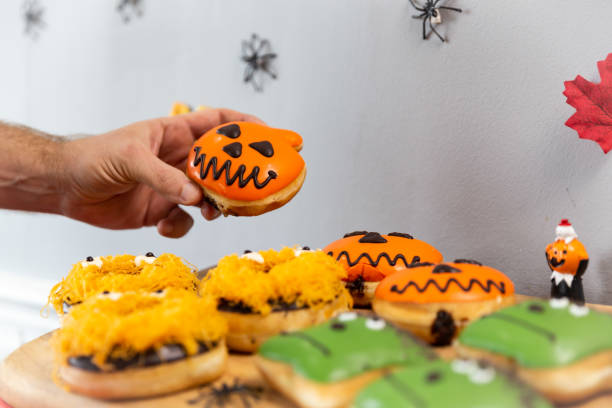 istock Person holding a Halloween donut arranged on a tray 1461592142