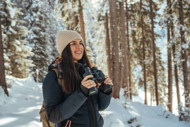 istock Young curious hiker woman walking in winter forest with backpack 1461592359
