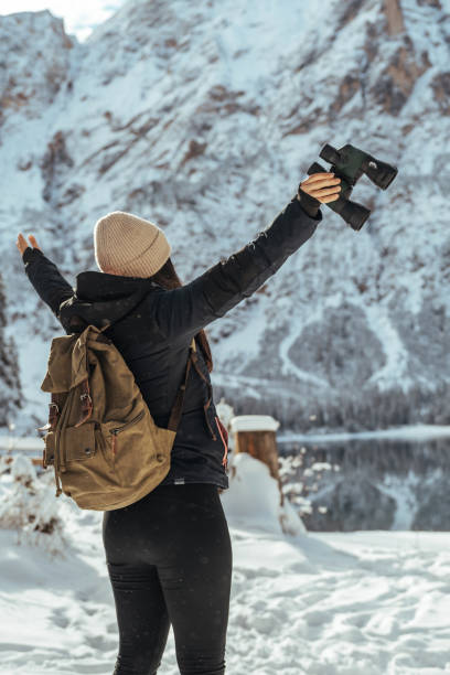 istock Woman with open arms enjoys a snowy day 1461592624