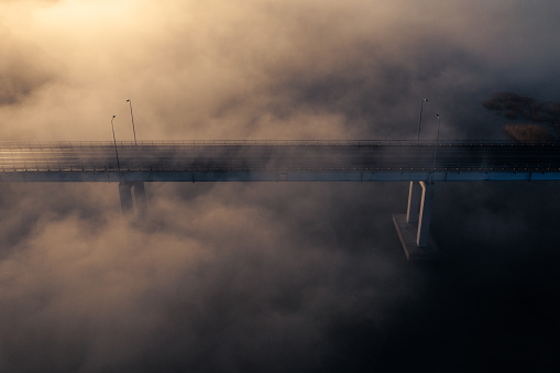 A bridge in the fog at sunset