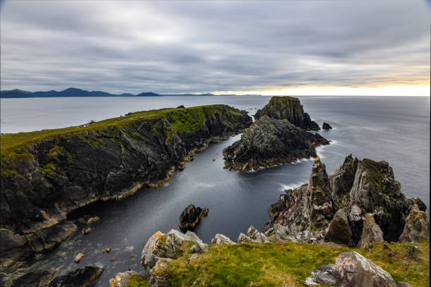 istock Aerial view of a clear calm sea surrounded by greenery-covered cliffs 1461593306