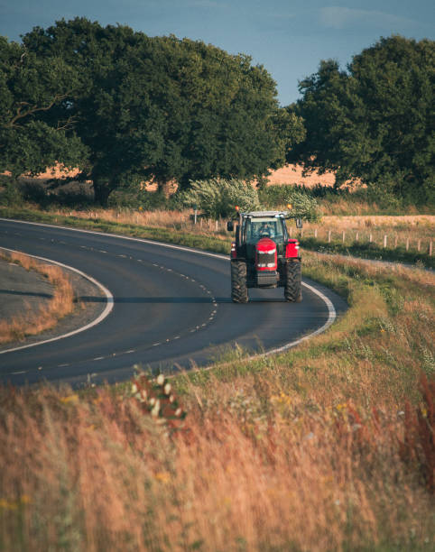 istock Vertical shot of a tractor on a rural road 1461595953