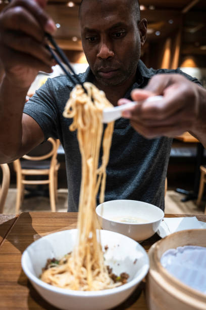 istock A man eating Jajangmyeon with chopsticks 1461596019
