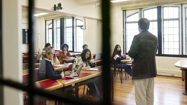Diverse student group interacting with mature educator