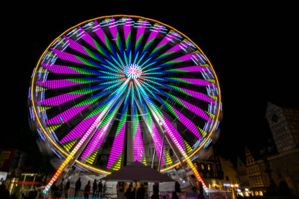 istock Low angle shot of an illuminated spinning Ferris wheel 1461596871