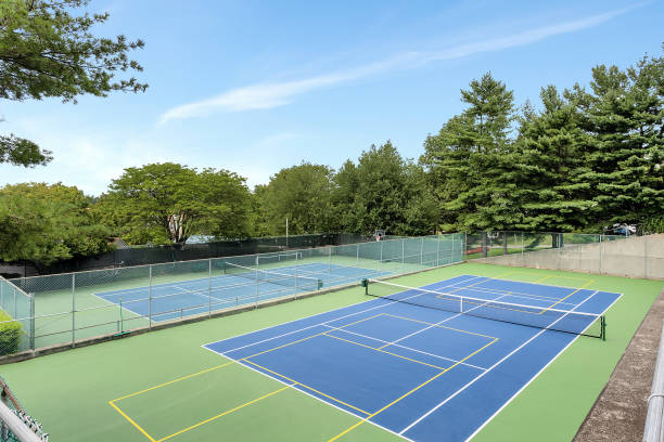 istock Tennis courts surrounded by green trees 1461597706