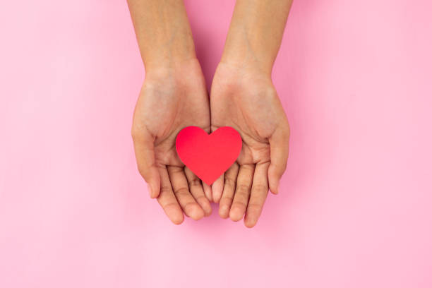 istock Hand holding love shape with pink background 1461598710