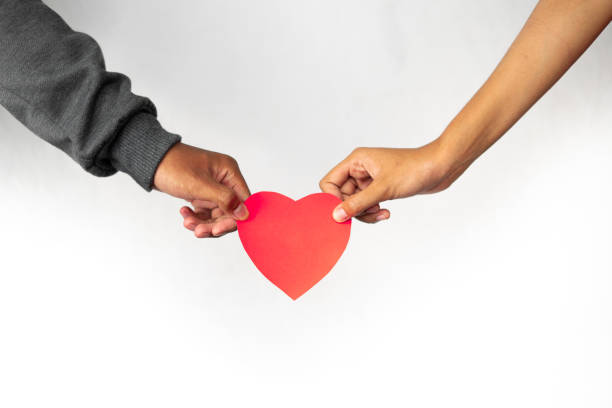istock Women and men hands holding hearts together 1461599520