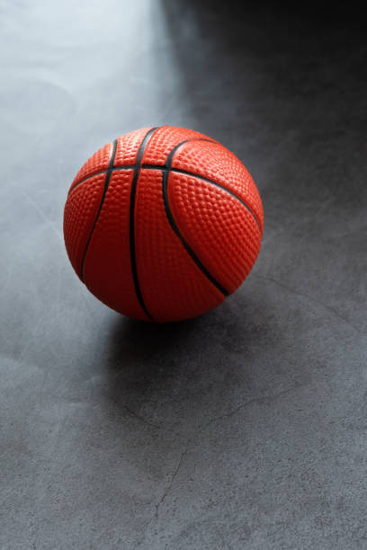 istock Small soft foam basketball on dark background 1461600574
