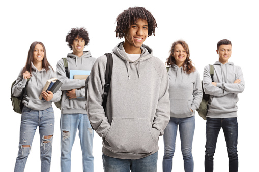 Group of male and female students in matching clothes isolated on white background