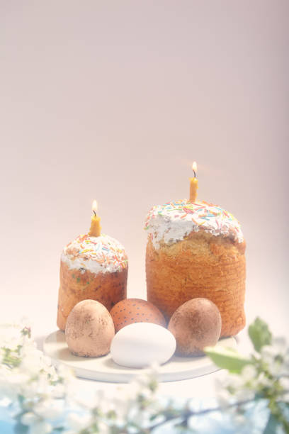 istock Two paski with burning candles and eggs on white background 1461601680