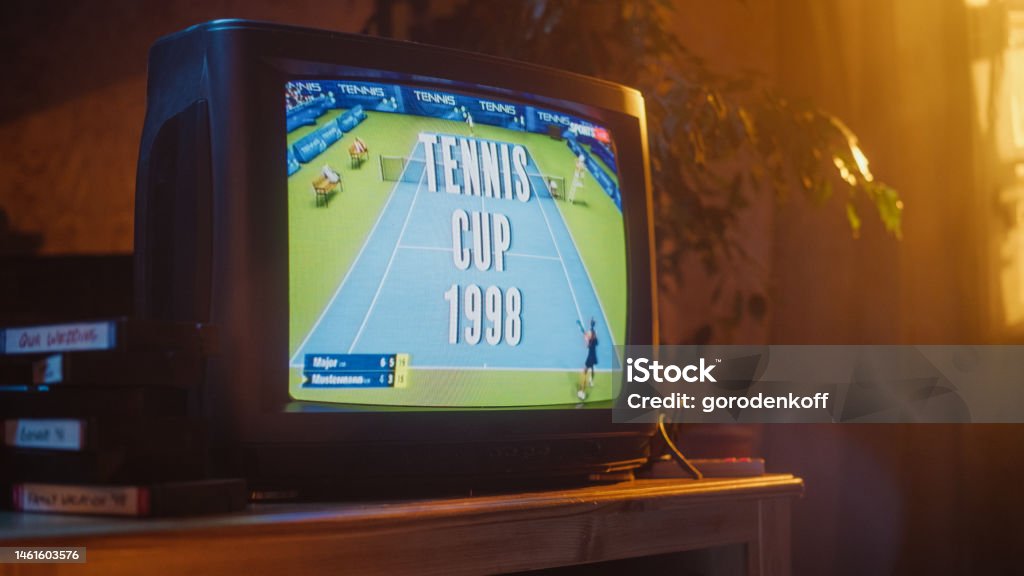 Close Up Footage of a Dated TV Set Screen with Live Sports Tennis Match Broadcast. Two Athletic Female Players in Staged World Cup 1998. Nostalgic Retro Nineties Technology Concept. Apartment Stock Photo