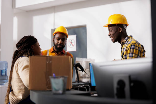 istock Delivery service employees discussing packages storing at warehouse reception 1461604056