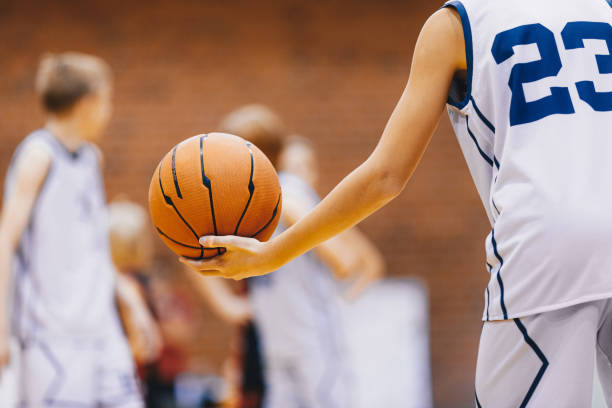 istock Happy Kids on Basketball Training Practice. Boy Playing With Basketball on Training Session. School Basketball Player Holding Ball 1461605852