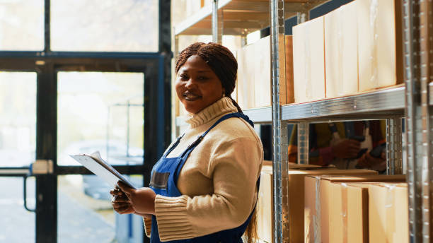 istock Female employee looking at inventory list on papers 1461607483