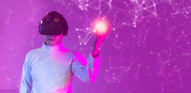 istock Man in white long sleeve t shirt wearing vr headset pose watching, touching digital virtual reality world, playing, connecting game online on pink background. Metaverse and Technology conceopt. 1461607729