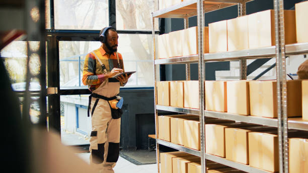 istock Young depot worker listening to music using tablet 1461608108