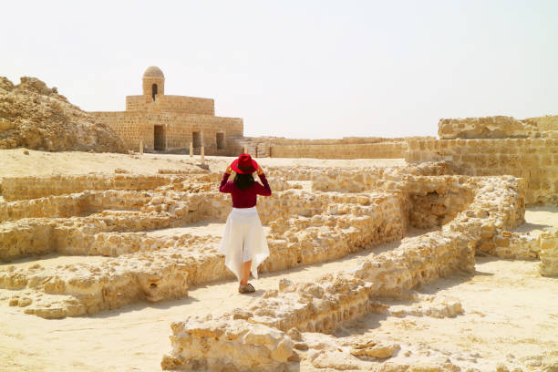 Female Visiting the Remains of the Bahrain Fort, the Ancient Harbour and Capital of Dilmun Civilization in Manama, Bahrain Female Visiting the Remains of the Bahrain Fort, the Ancient Harbour and Capital of Dilmun Civilization in Manama, Bahrain, ( Self Portrait ) bahrain stock pictures, royalty-free photos & images