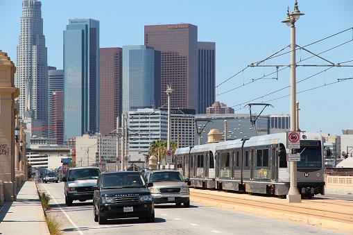 Car traffic and Metro Rail tram in Los Angeles. LA Metro Rail system had daily ridership of 357 thousand in January 2014.