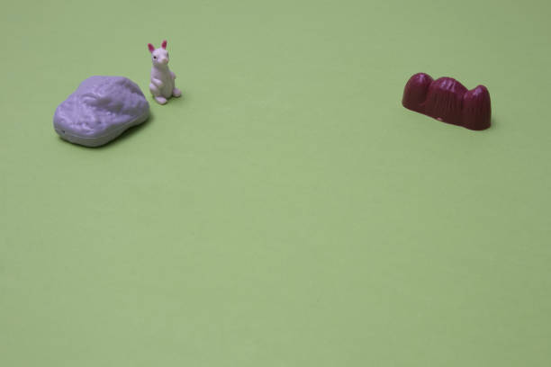 istock White rabbit in left up corner with rocks on a green background with copy space. A minimalist Chinese New Year composition. 1461608801