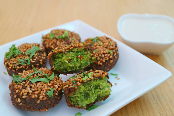 Close-up of ready-made Turkish fried donuts Lokma in slow motion falling on pink plate. Ramadan. High quality 4k footage