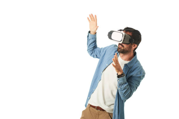 istock a man with virtual reality goggles making hand gestures isolated on a white background 1461609720