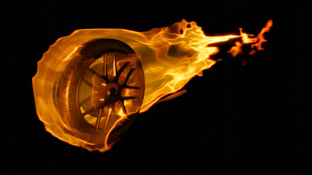 Burning car wheel with fire trail on black isolated background