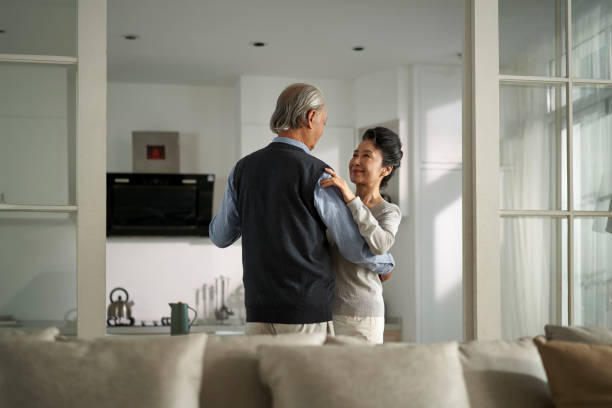 istock loving asian old couple dancing at home 1461611875