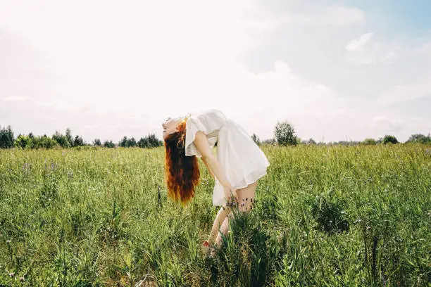 Photo of Happy woman with long hair on sky background.