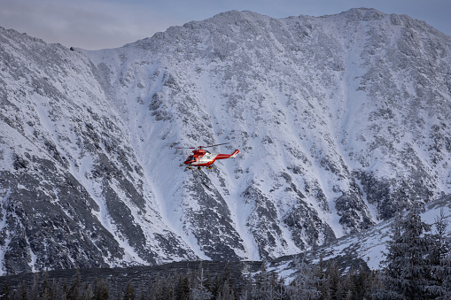 Zakopane, Poland - January 6, 2023: Rescue TOPR helicopter in the winter Tatra Mountains, Poland