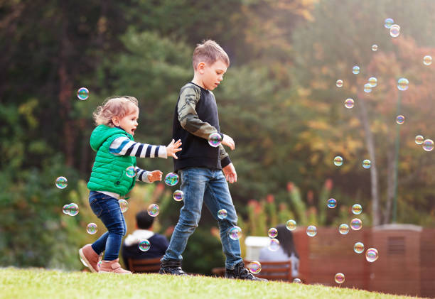 istock brother and baby are catching  soap bubbles 1461614950