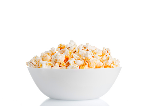 a plate of popcorn macro on a white background close-up