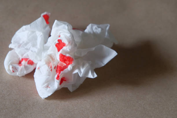 istock Red blood stained on tissue paper isolated on dark background 1461615042