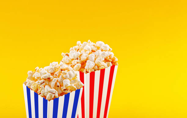 istock Glass with popcorn on a yellow background 1461615123