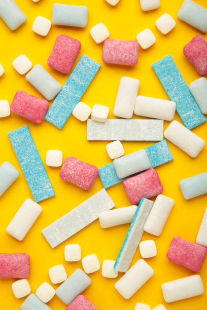 istock Different chewing gums on yellow background. Vertical photo 1461615400
