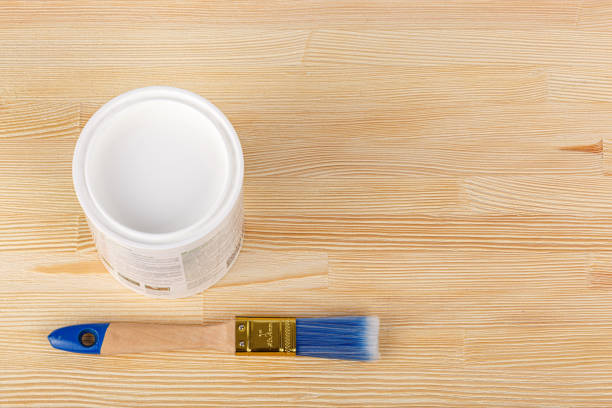 istock white paint with a brush on a wooden background with texture 1461616336