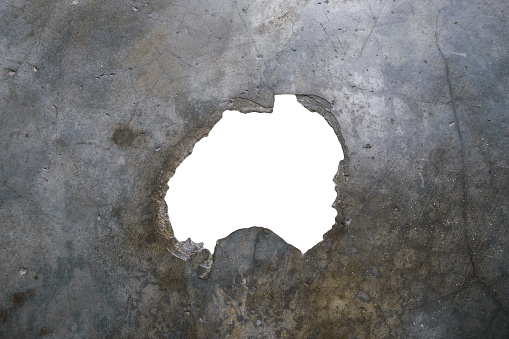 Hole with white background and clipping path in the middle of grey stone surface.