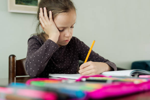 istock Girl doing homework while sitting in living room 1461619168