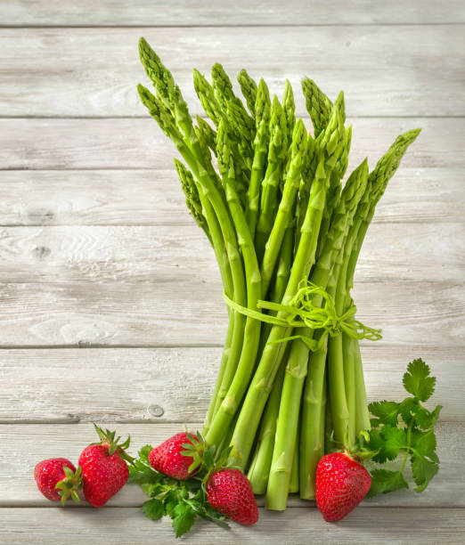 istock Asparagus on bright pale wood 1461619255
