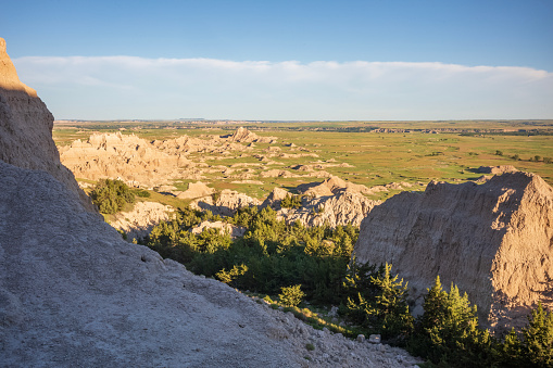 Badlands National Park in South Dakota consists of more than 242,000 acres of land. Dramatic landscapes including rock formations, steep canyons, towering spires and prairie grass are home to Bison, bighorn sheep and prairie dogs. Erosion has revealed sedimentary layers of purple and yellow (shale), tan and gray (sand and gravel), red and orange (iron oxides) and white (volcanic ash). It was designated a National Monument in 1939 and re-designated a National Park in 1978.