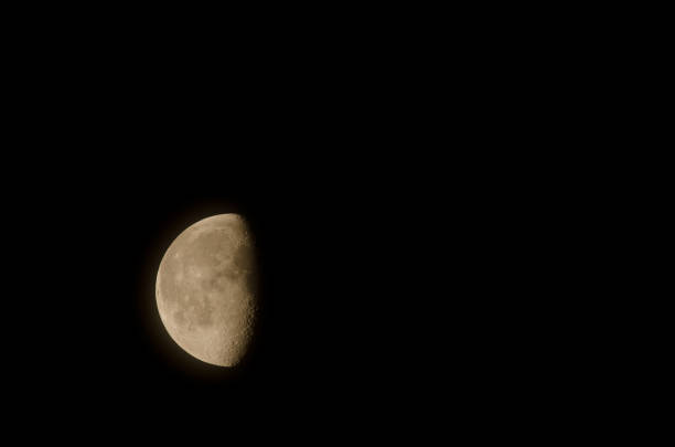 Last quarter of the moon half-covered by the clouds. Las Palmas de Gran Canaria. Gran Canaria. Canary Islands. Spain.