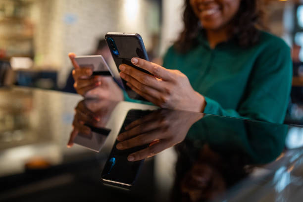 istock Woman making purchase with credit card 1461623732