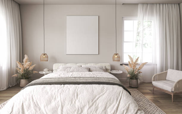 istock Light home interior wall mock up with white bed and dry plant in coastal bedroom. Empty picture frame mockup. Free space on front. 3d rendering. High quality 3d illustration 1461624553
